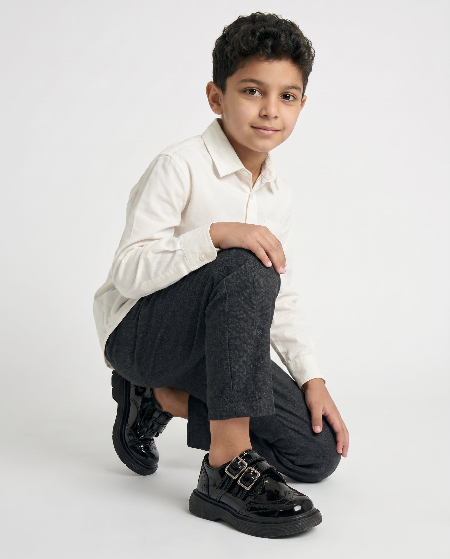 Boys glossy black patent monk shoe — three-quarter angle