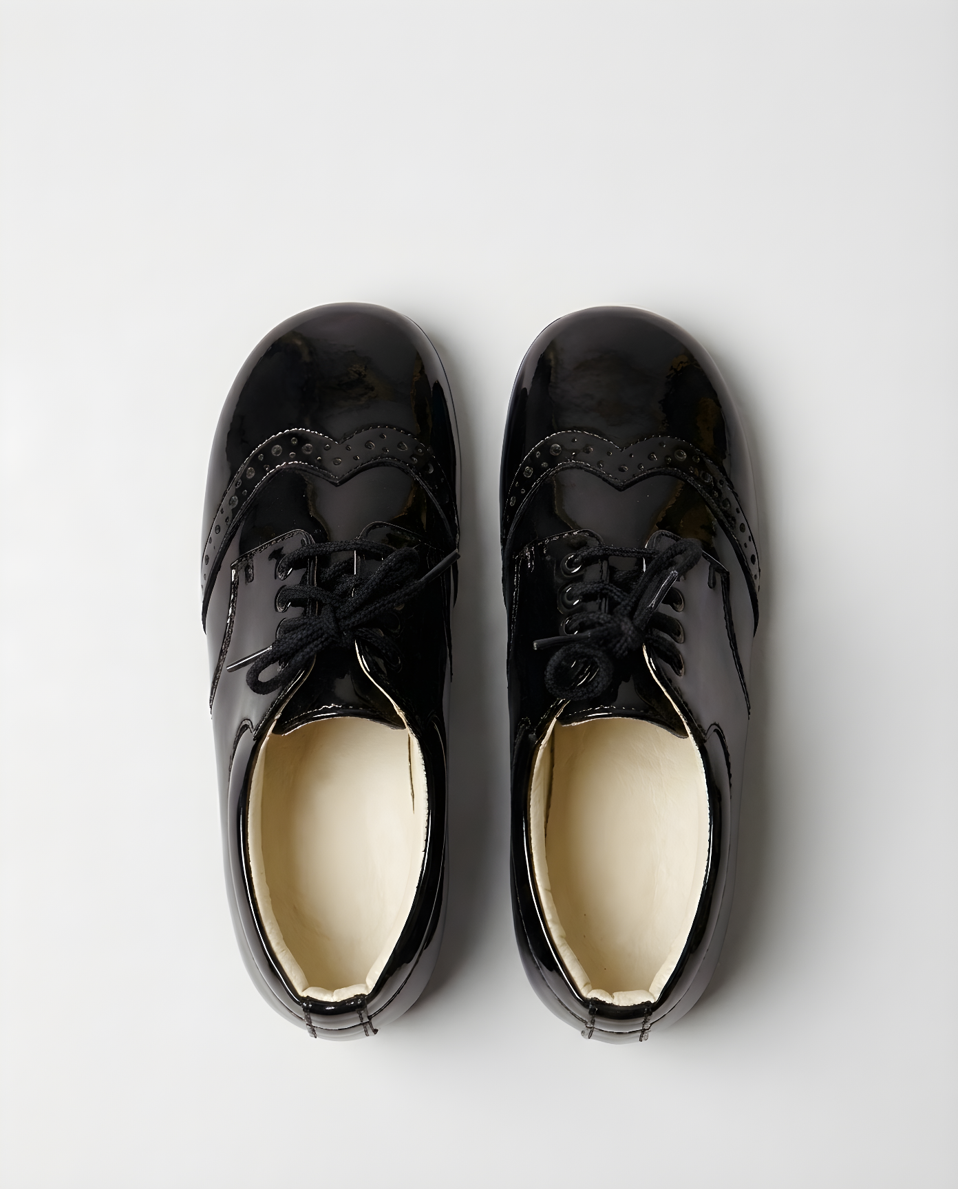 Boys classic black patent wingtip shoe — sole view