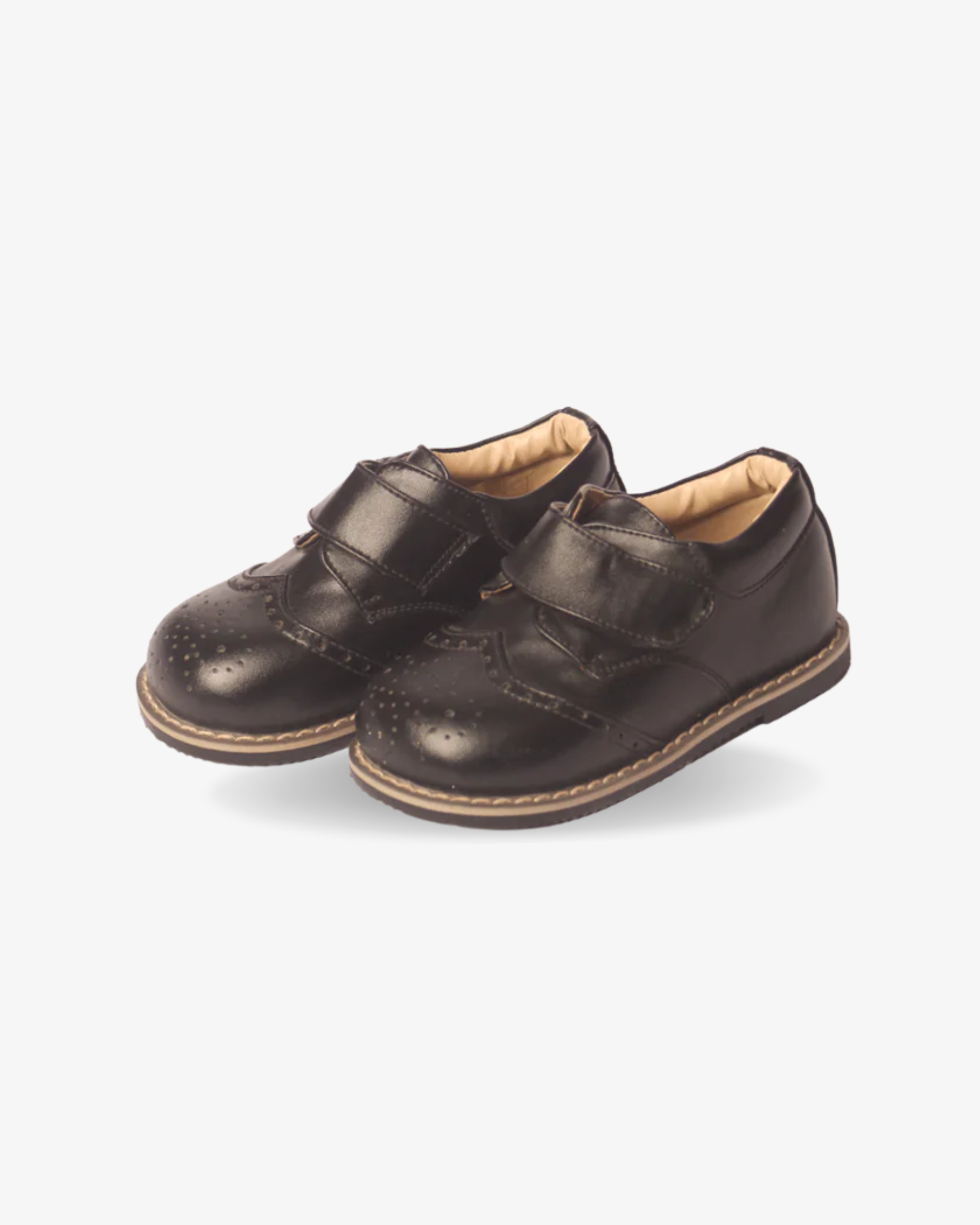 Boys classic black strap wingtip shoe — sole view