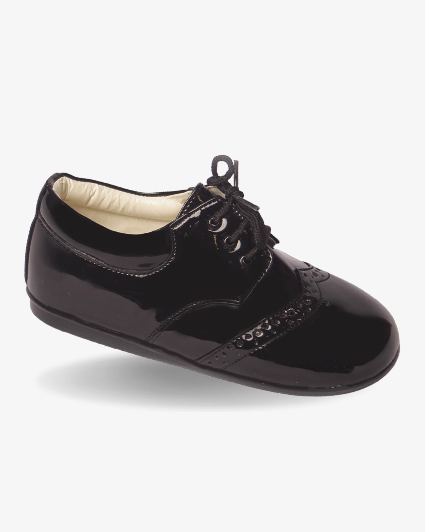 Boys classic black patent wingtip shoe — front view